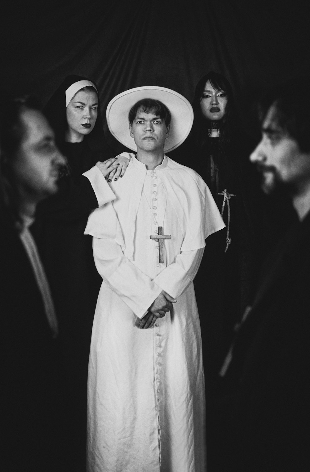 a black and white photo of a woman in a priest's outfit