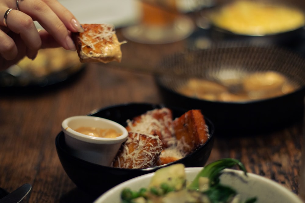 a close up of a person eating food at a table