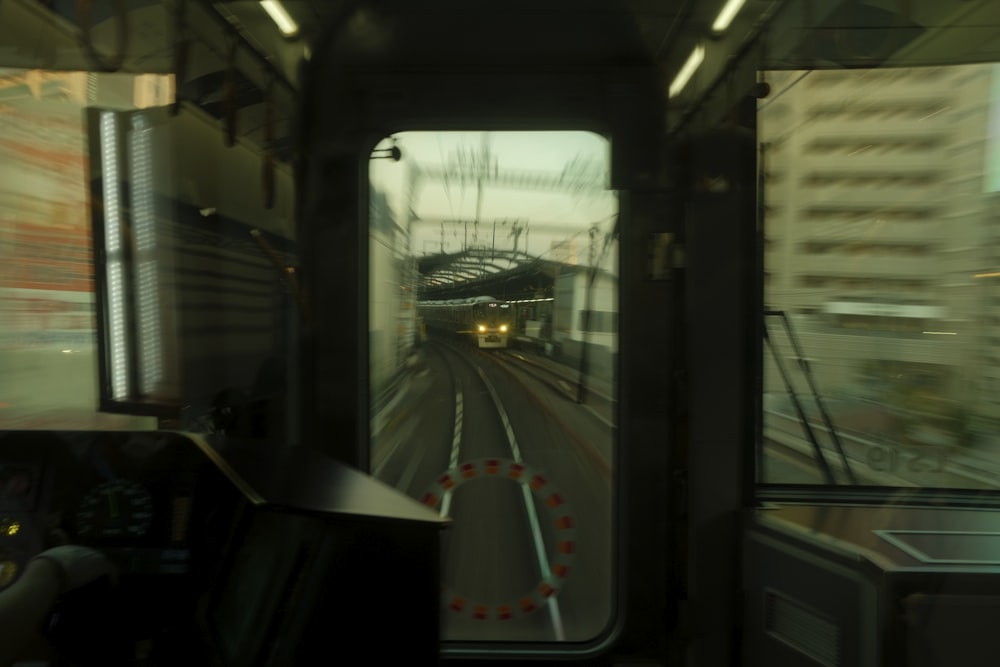 a train traveling down train tracks next to tall buildings