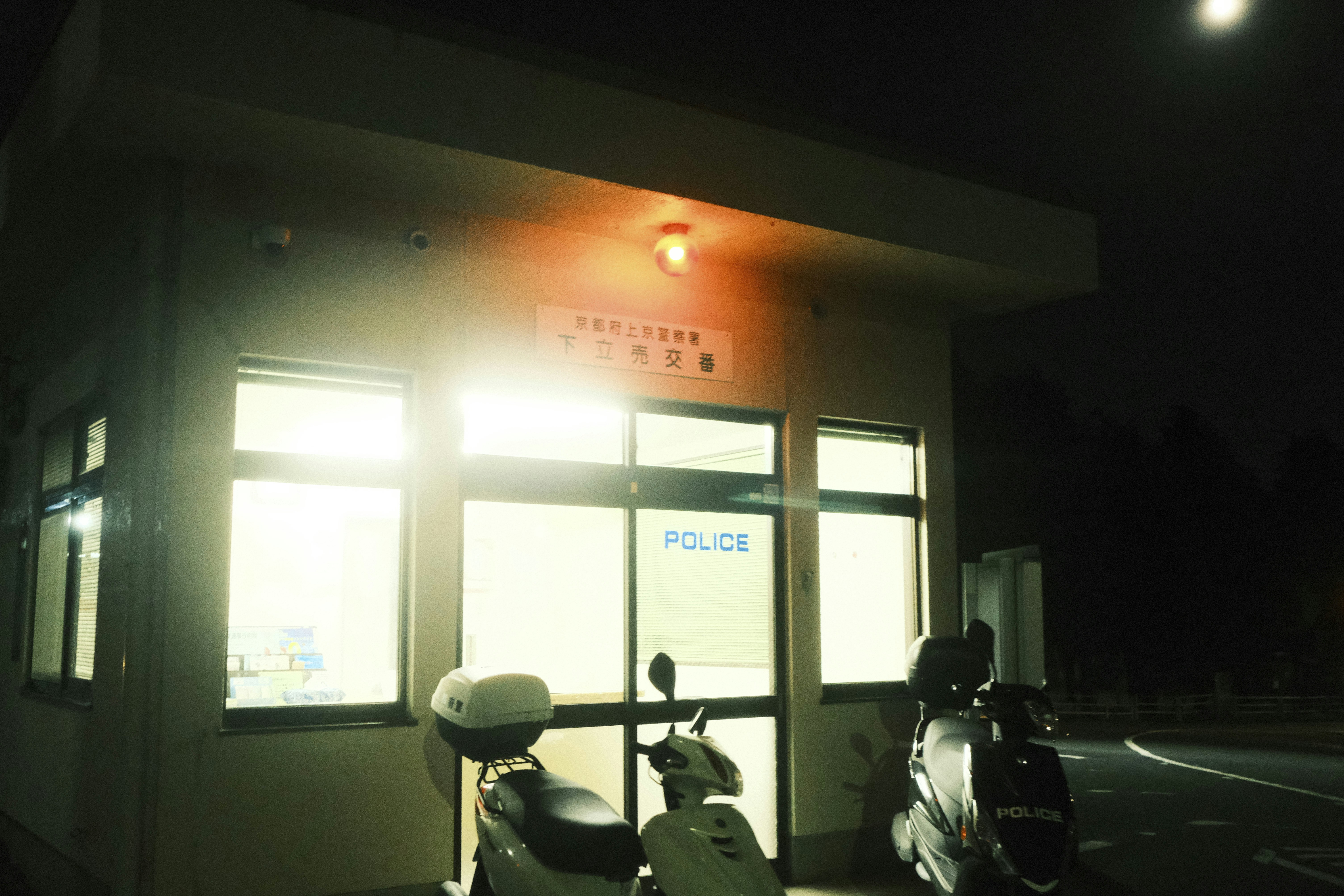a motorcycle parked in front of a building at night