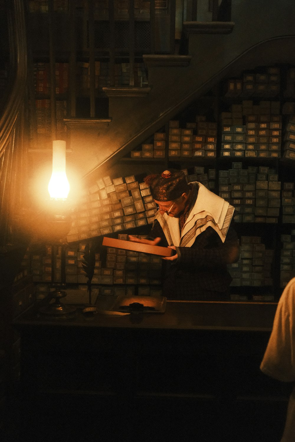 a person sitting at a desk in a library