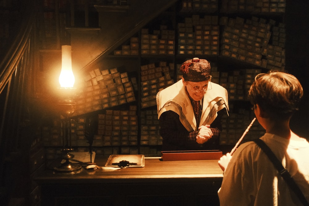 a man and a woman standing in front of a desk