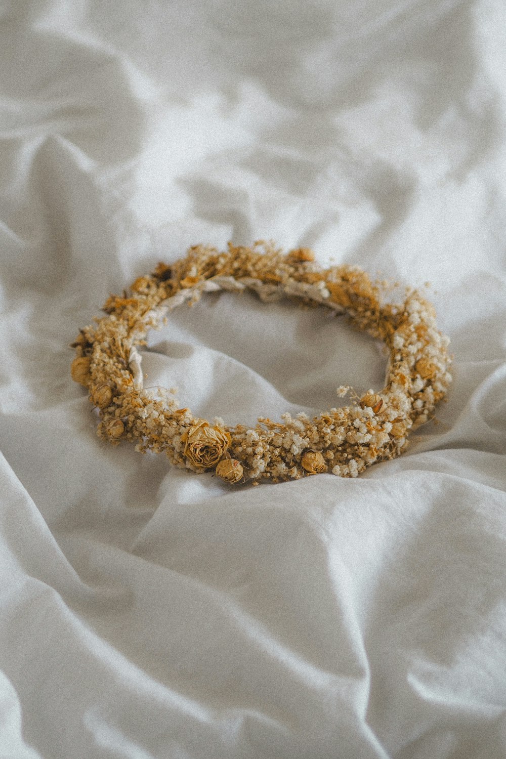 a close up of a bracelet on a bed