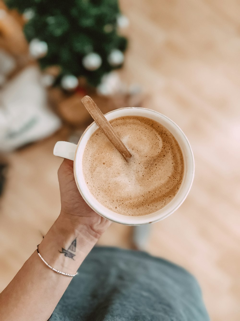 a person holding a cup of coffee in their hand