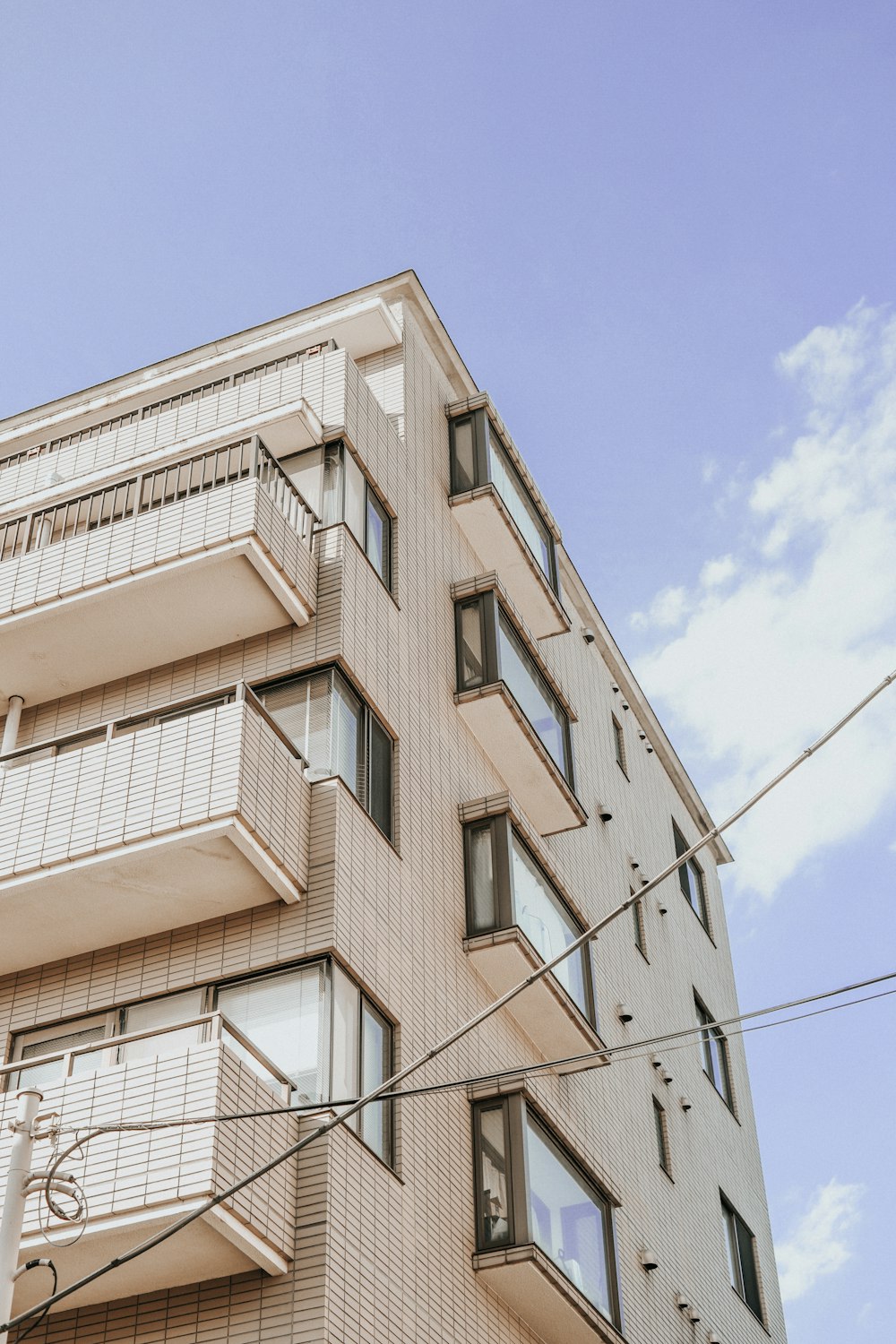 a tall building with balconies on the top of it