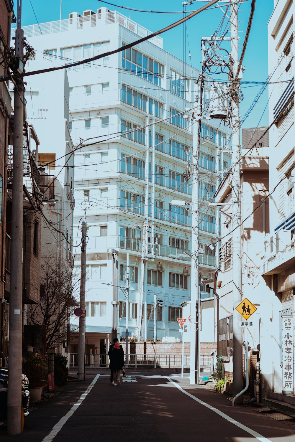 a man riding a bike down a street next to tall buildings