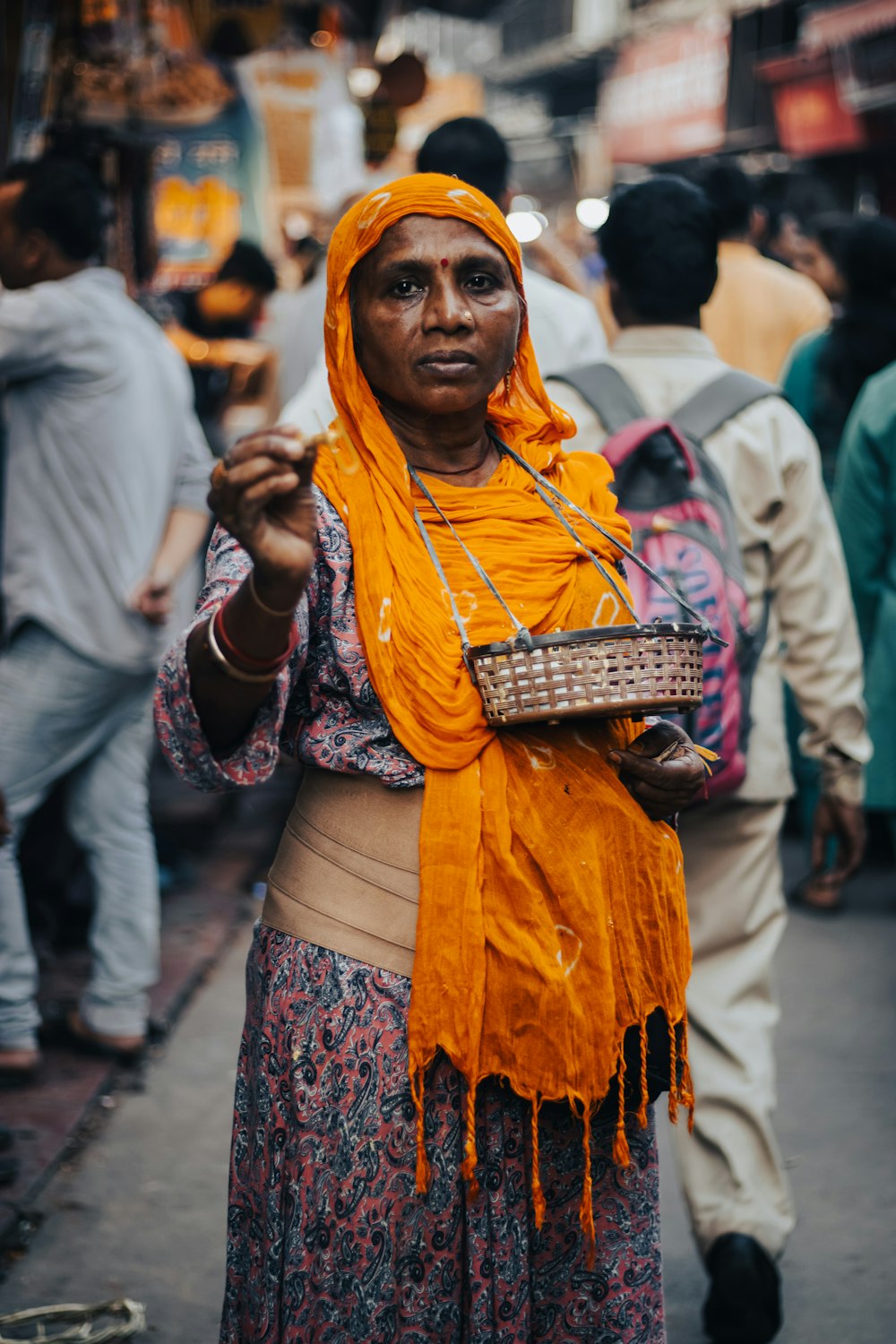 a woman wearing a yellow scarf and holding a basket