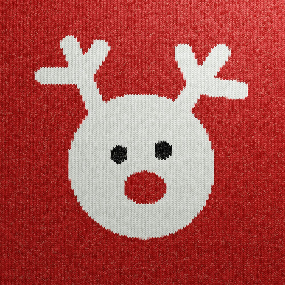 a close up of a knitted picture of a reindeer
