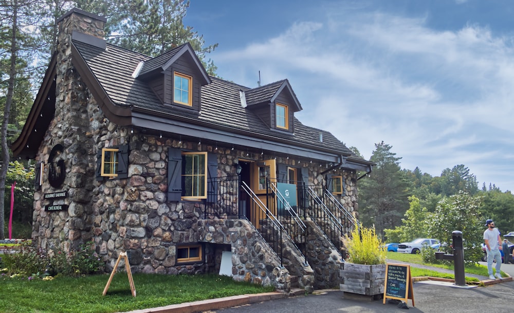 a house made of rocks with a porch and windows