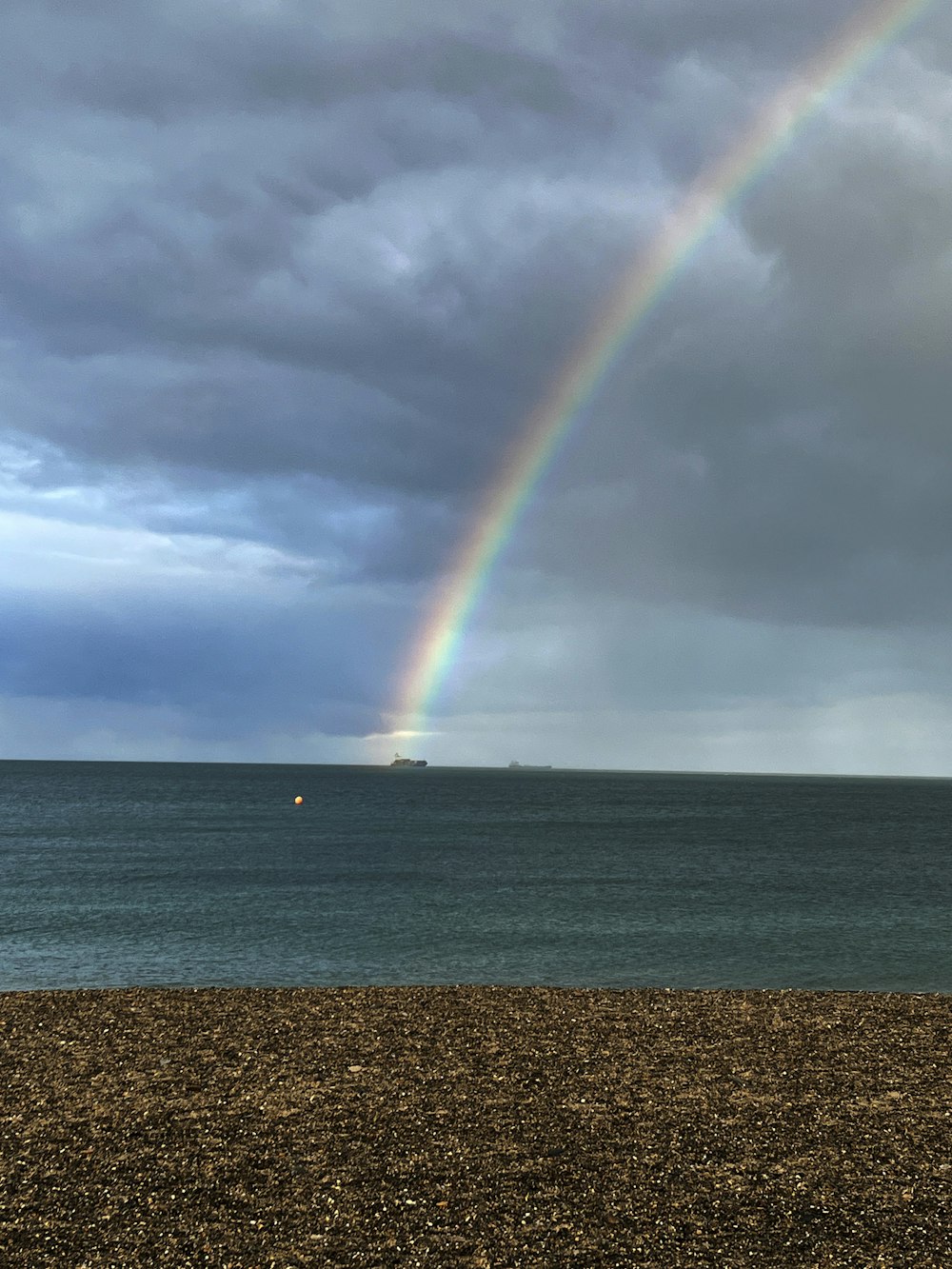 a rainbow in the sky over a body of water