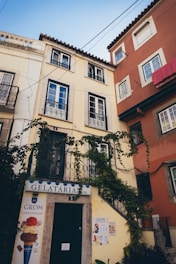 A cozy street in Italy with colorful buildings and a traveler enjoying a gelato.