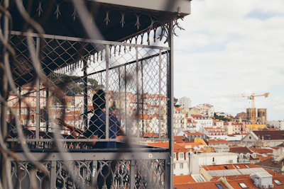 a man standing on top of a balcony next to a fence