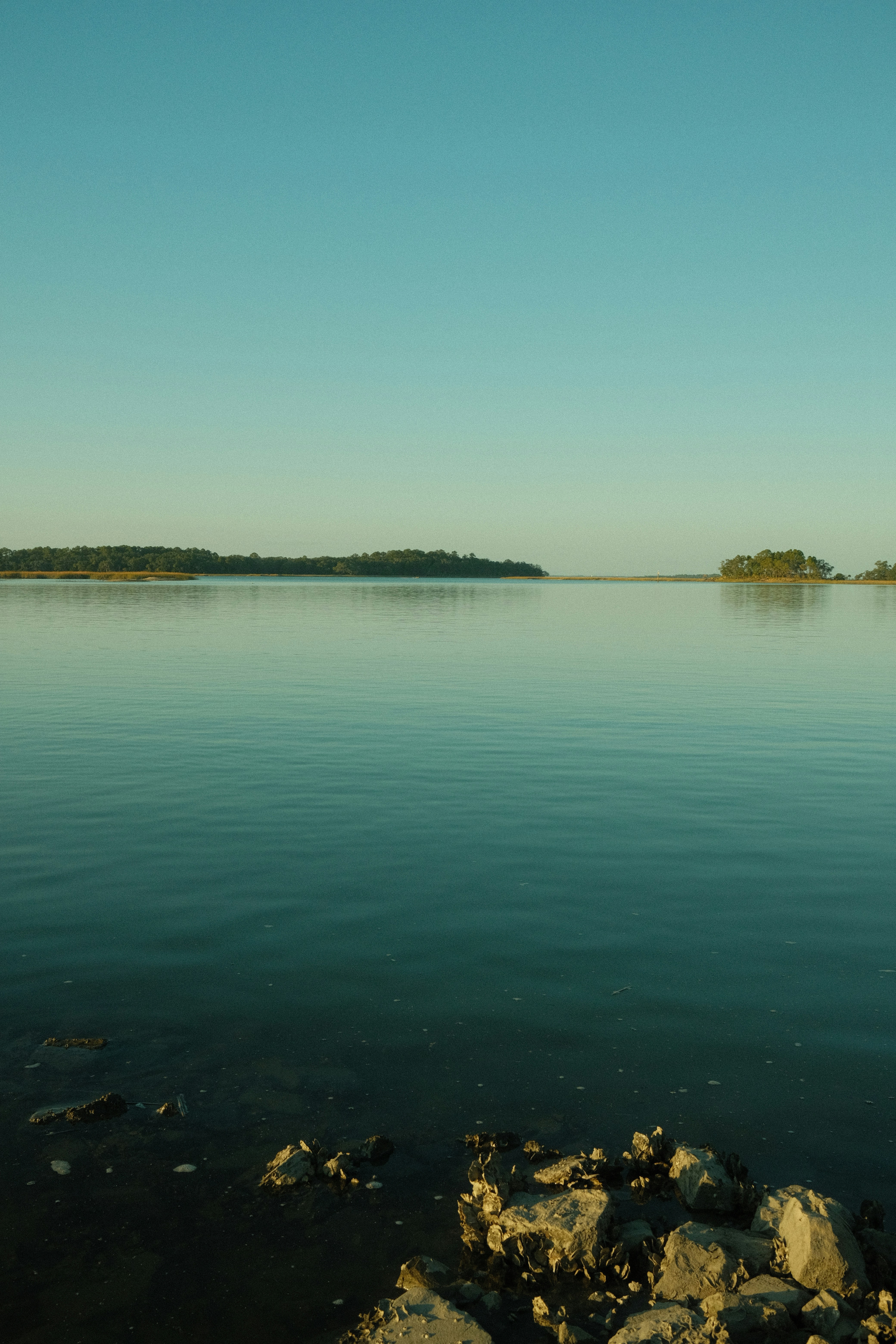 a large body of water with a small island in the distance