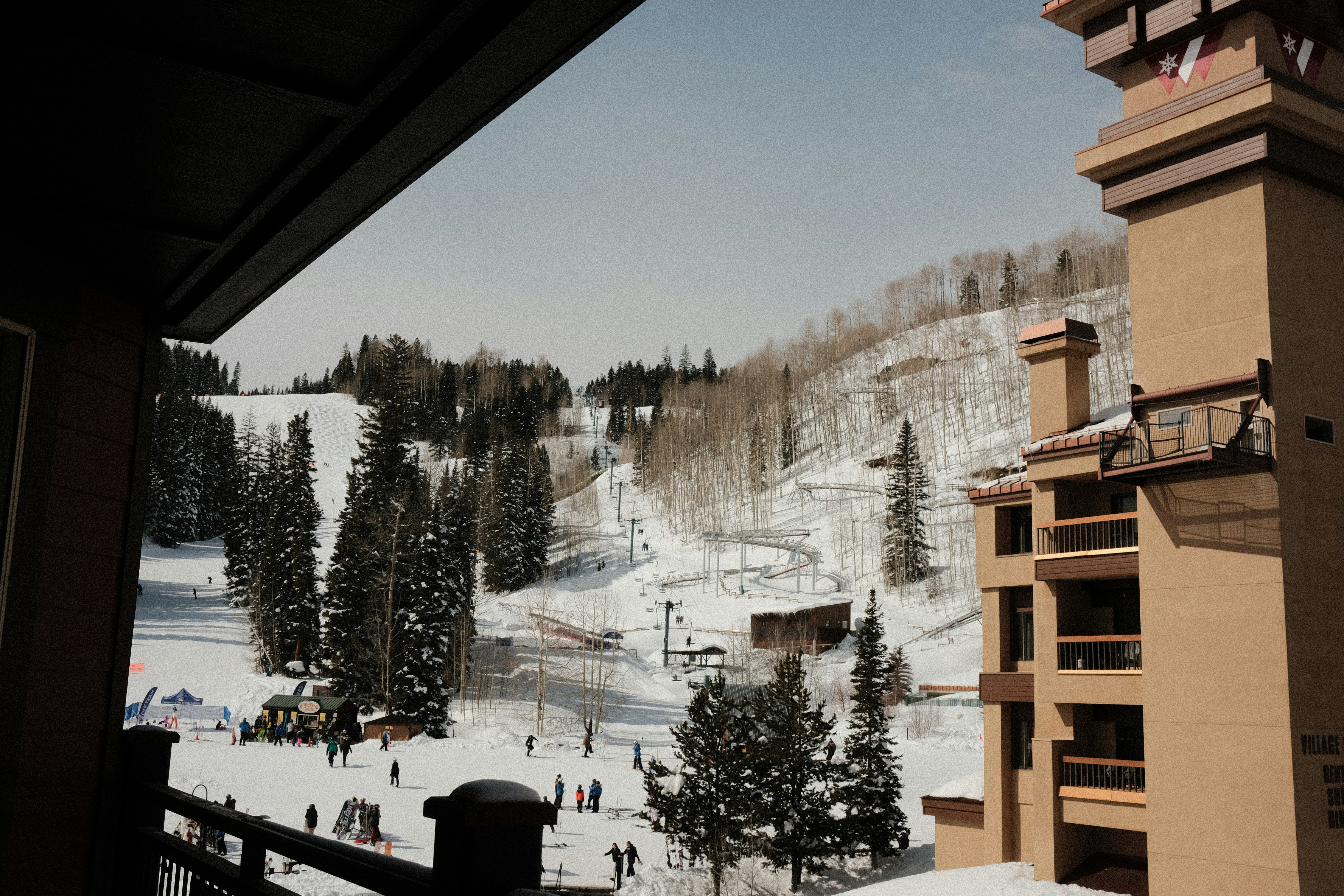 a view of a ski resort from a balcony, 