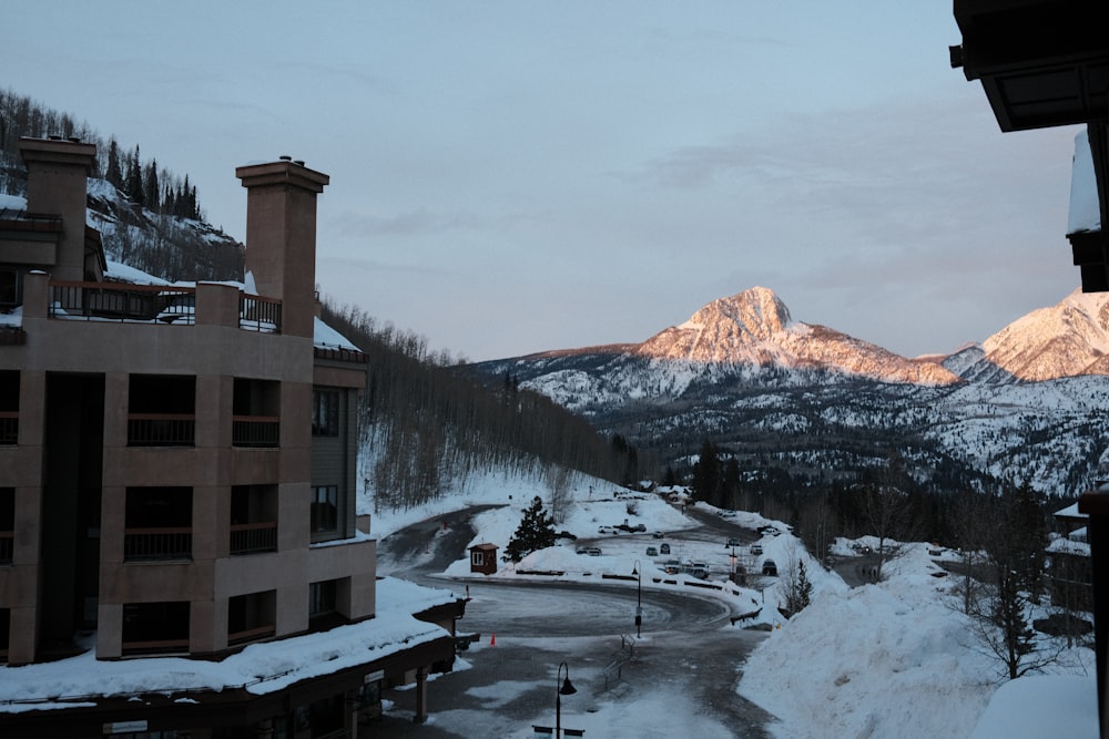 a view of a snowy mountain range from a hotel