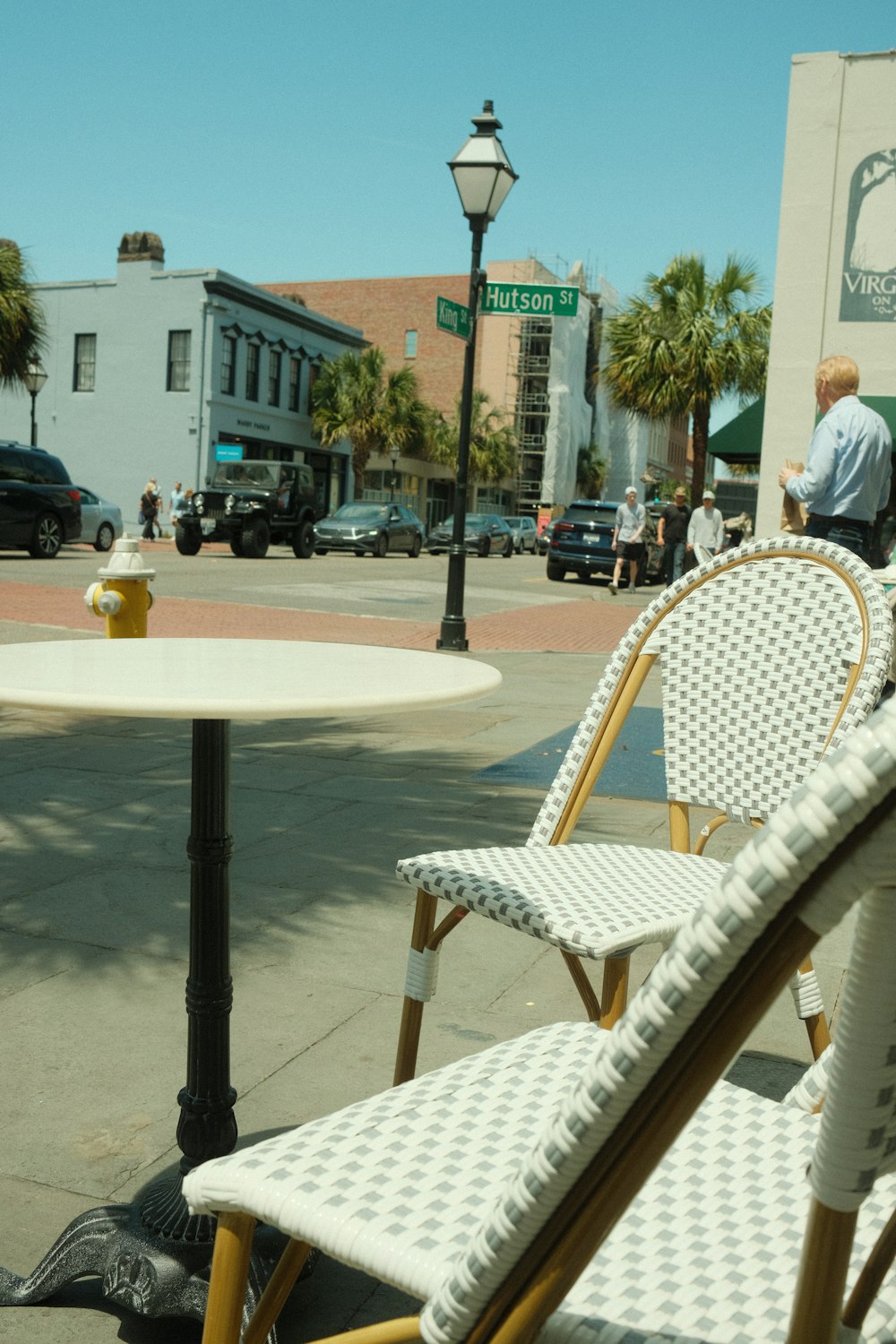 a couple of chairs and a table on a sidewalk