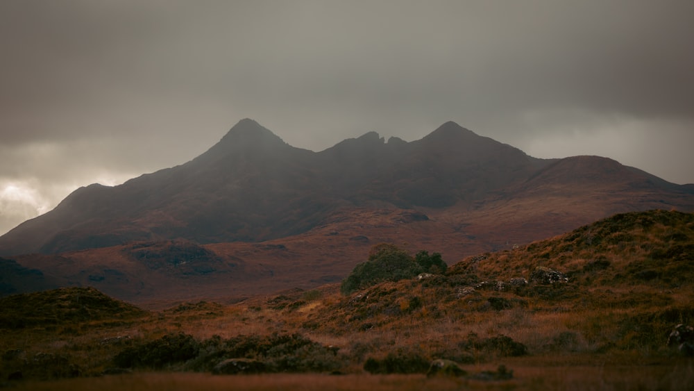 a mountain range with a few clouds in the sky