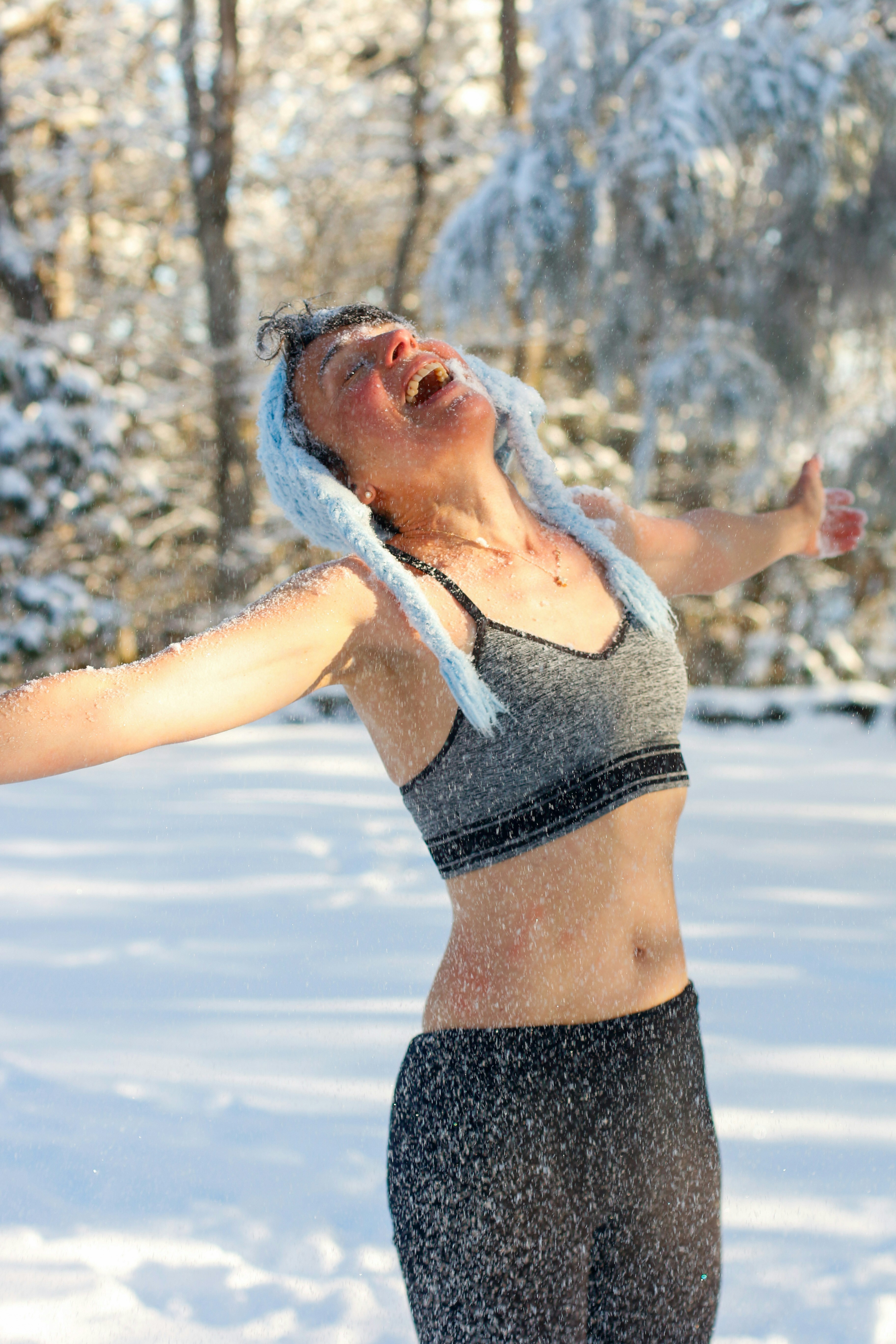 a woman in the snow with her arms outstretched