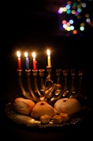 Children joyfully lighting candles together during a Hanukkah event in Shapira neighborhood