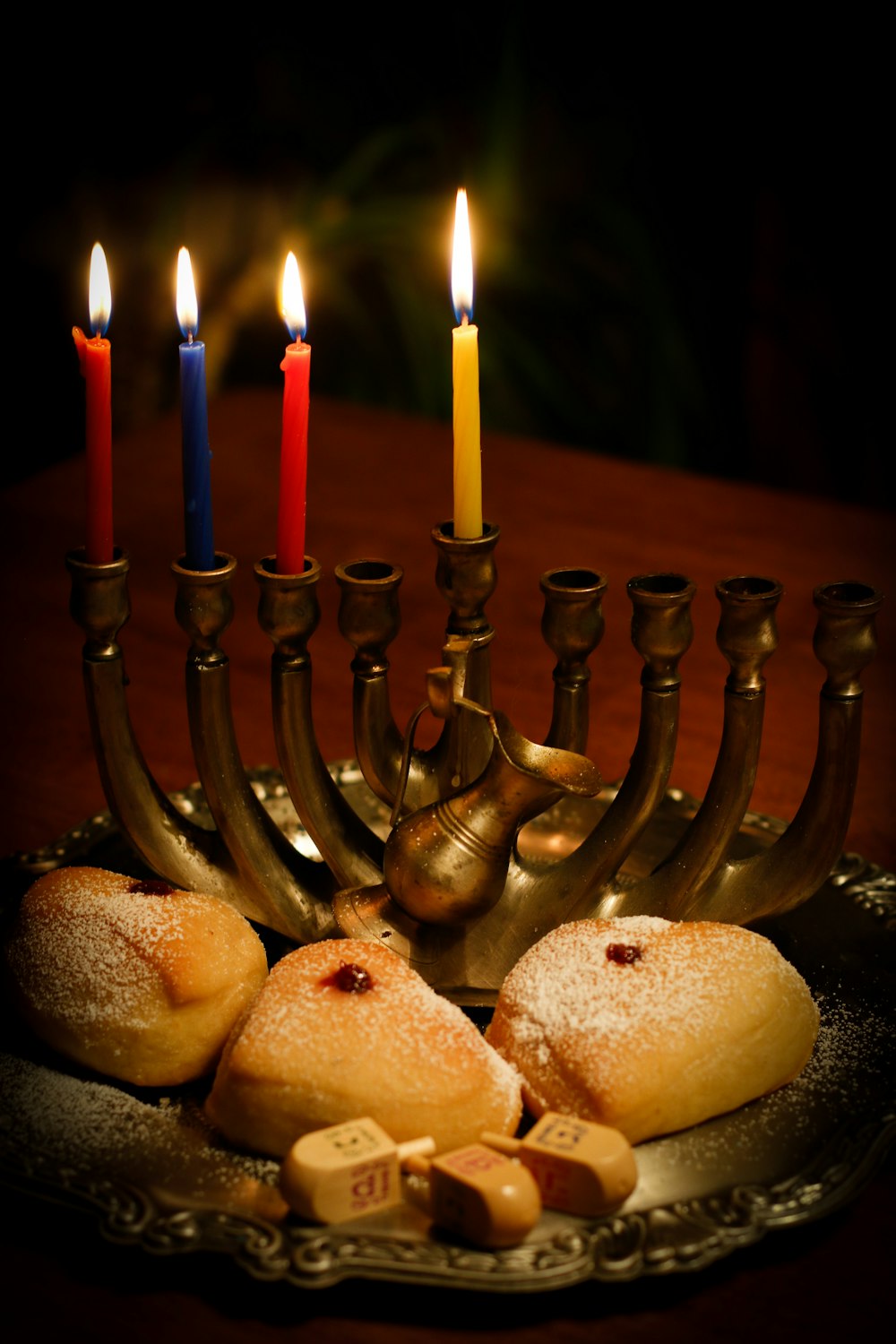 a hanukkah menorah with candles and cookies