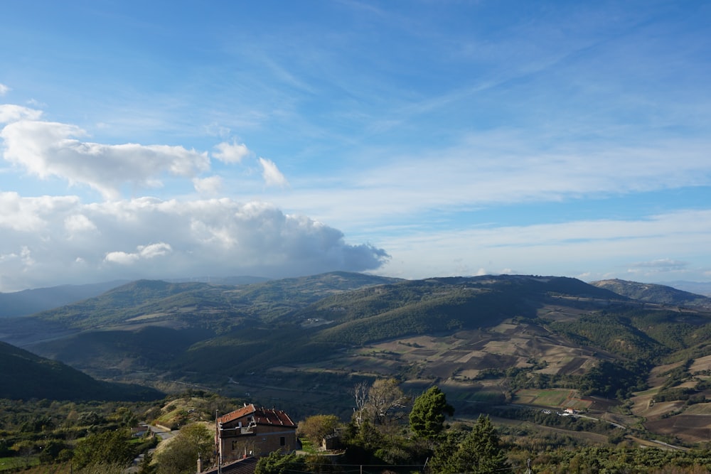 a view of a mountain range with a house in the foreground