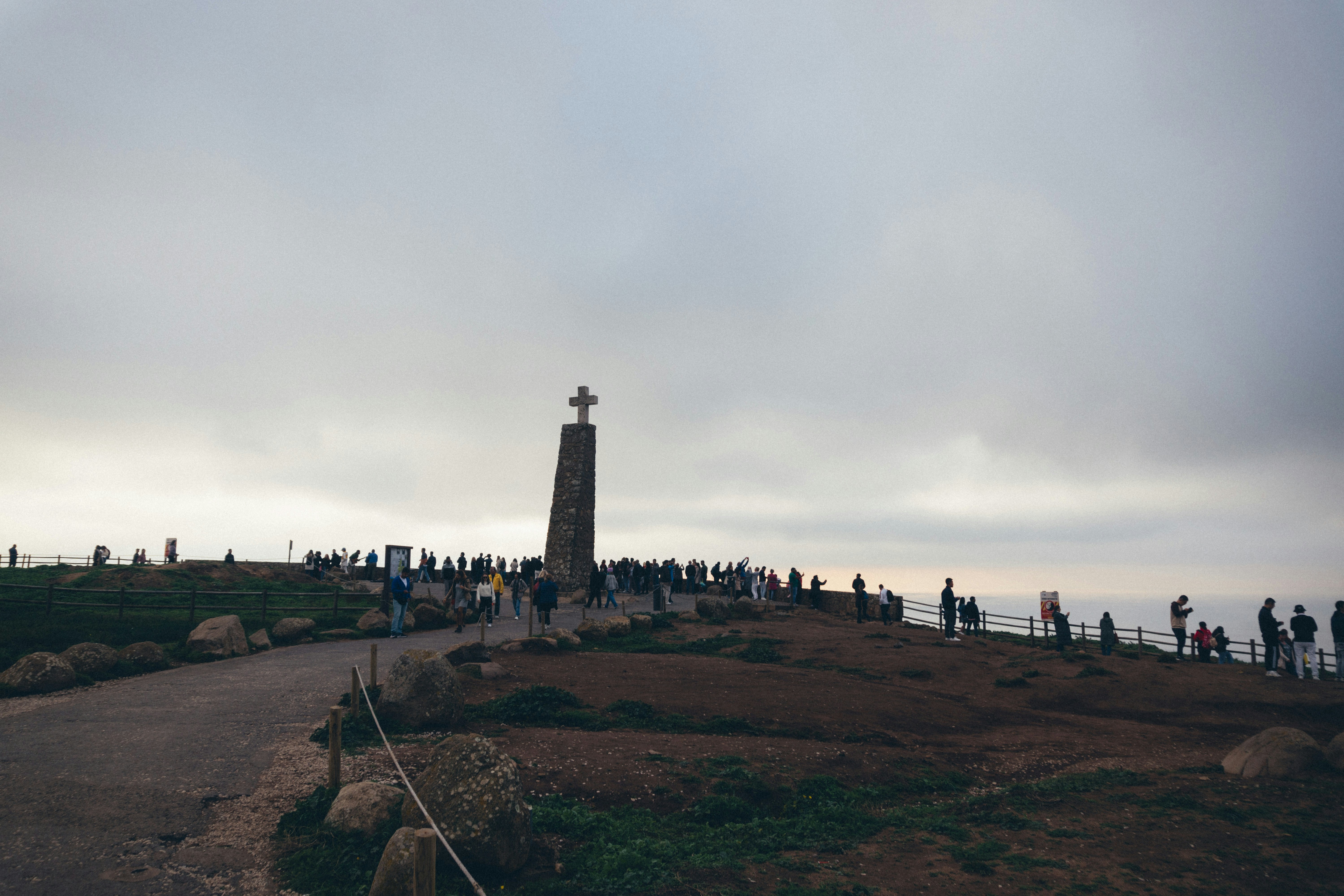 a group of people standing on top of a hill