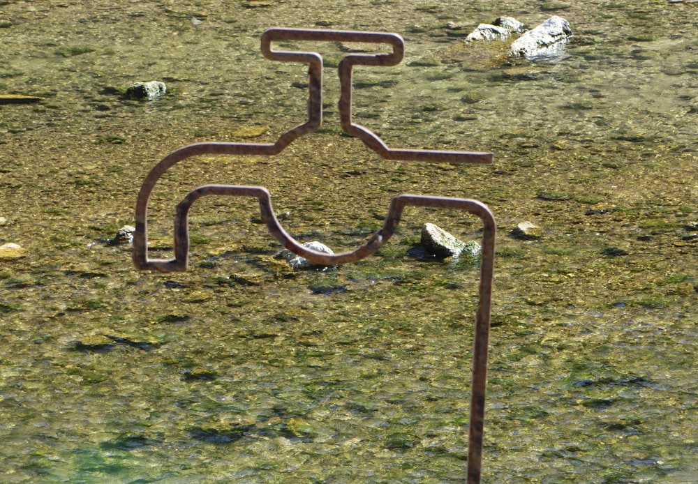 a metal sculpture in the middle of a field