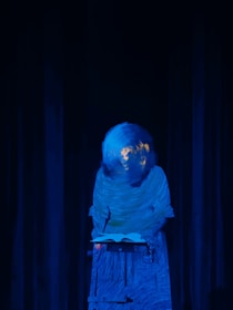 A shadowy figure behind a desk symbolizing political power and control.