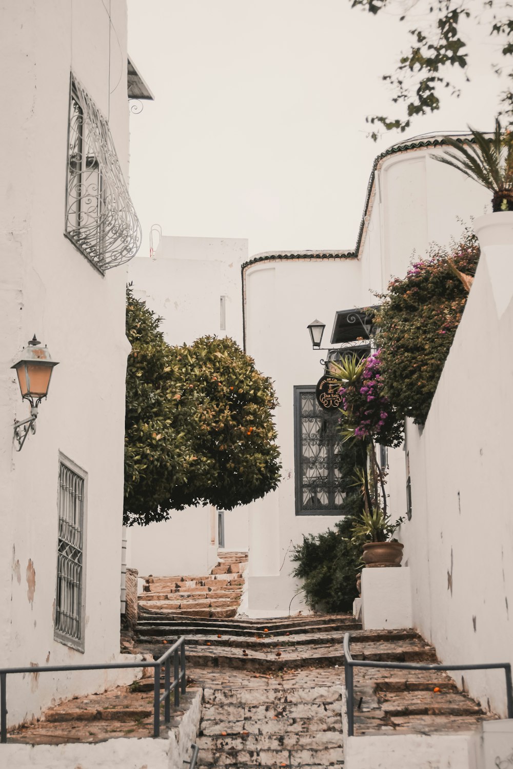 a narrow street with steps leading up to a building