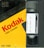 A Kodak VHS T-120 video cassette, presented in its original yellow and black packaging. The cassette is partially visible next to the box, with a label on it that has handwritten text.