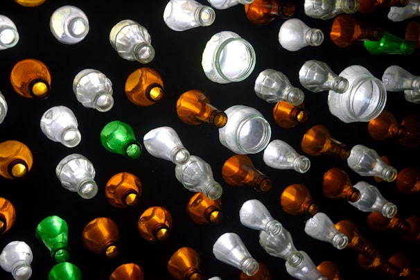 A close-up of various sizes of transparent bottles arranged neatly.