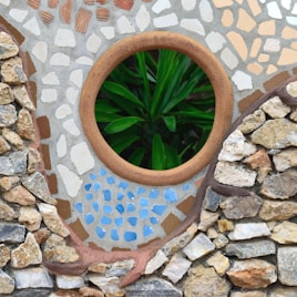 a potted plant sitting inside of a stone wall