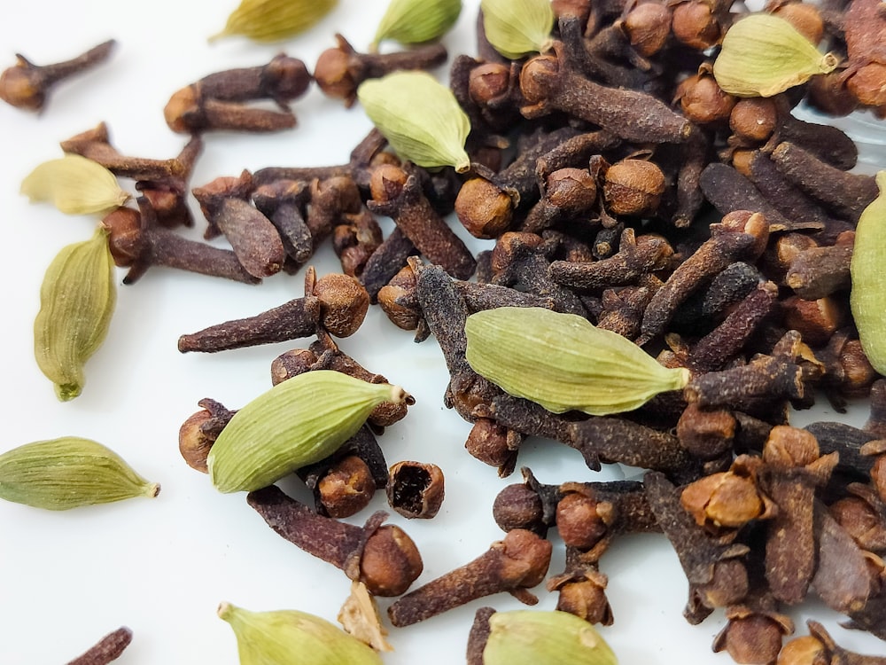 a pile of nuts and seeds on a white surface