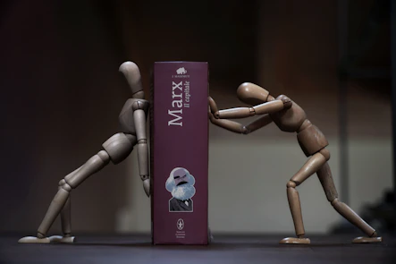 a couple of wooden mannequins standing next to a box