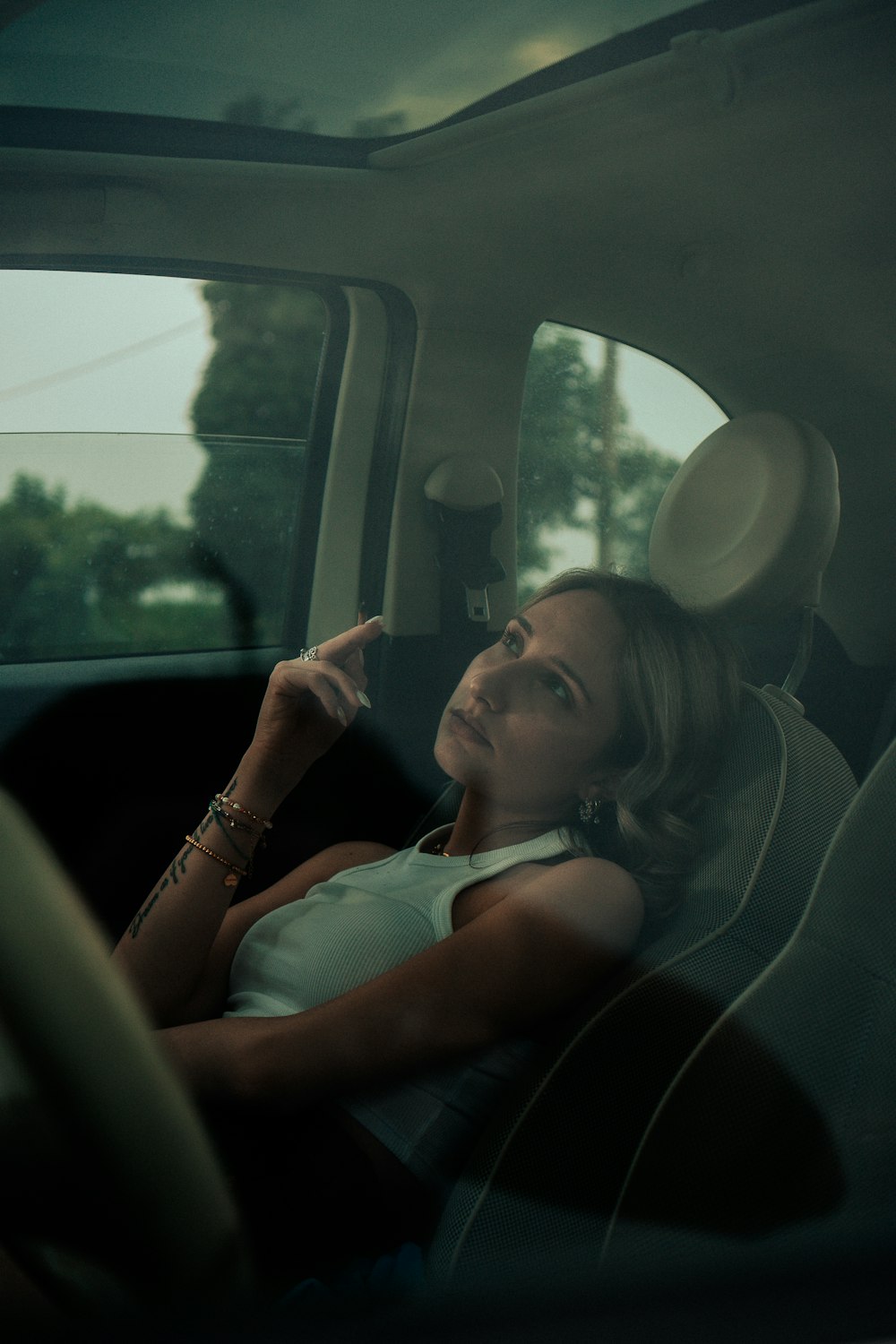 a woman sitting in the back seat of a car