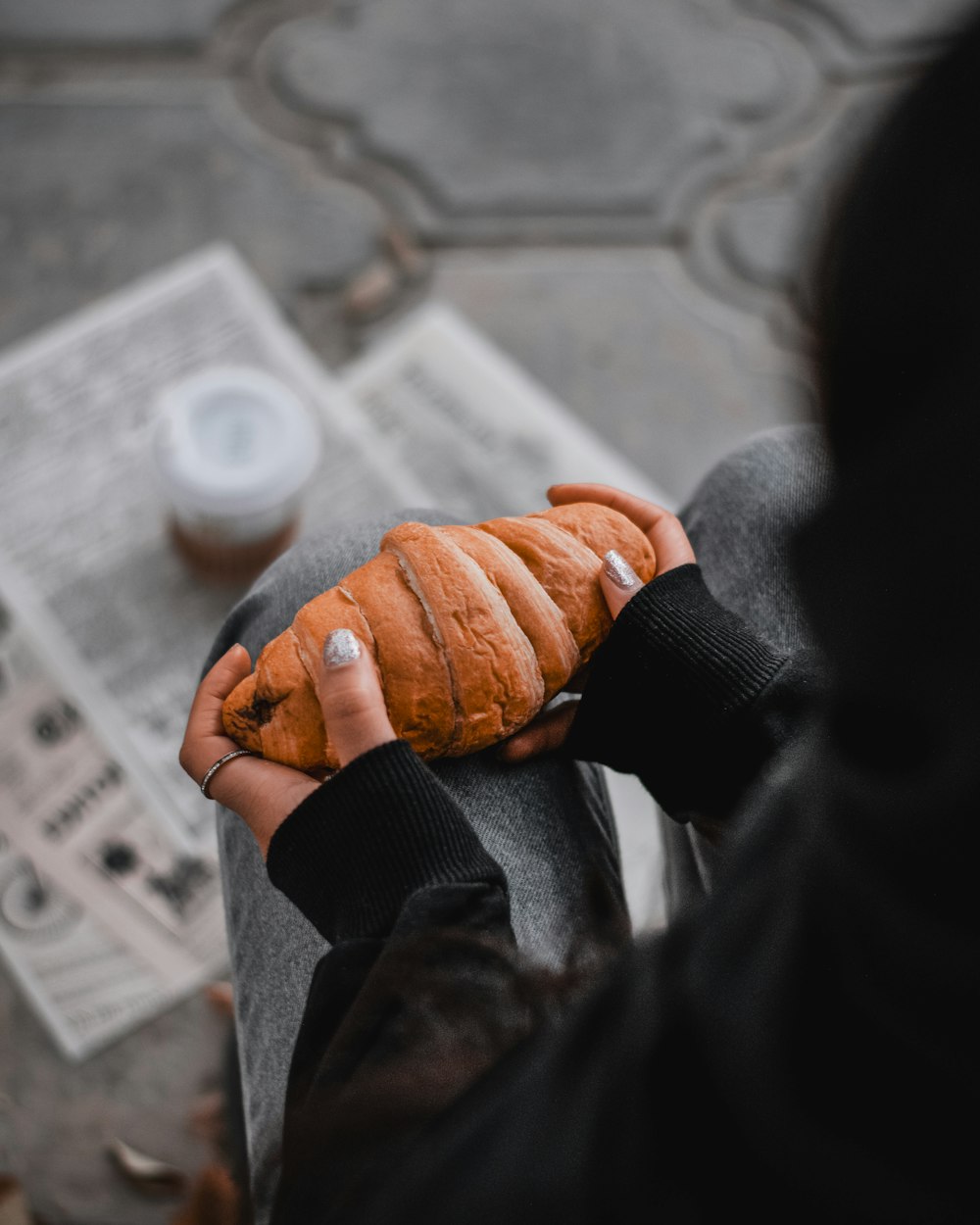 a person holding a piece of bread in their hands