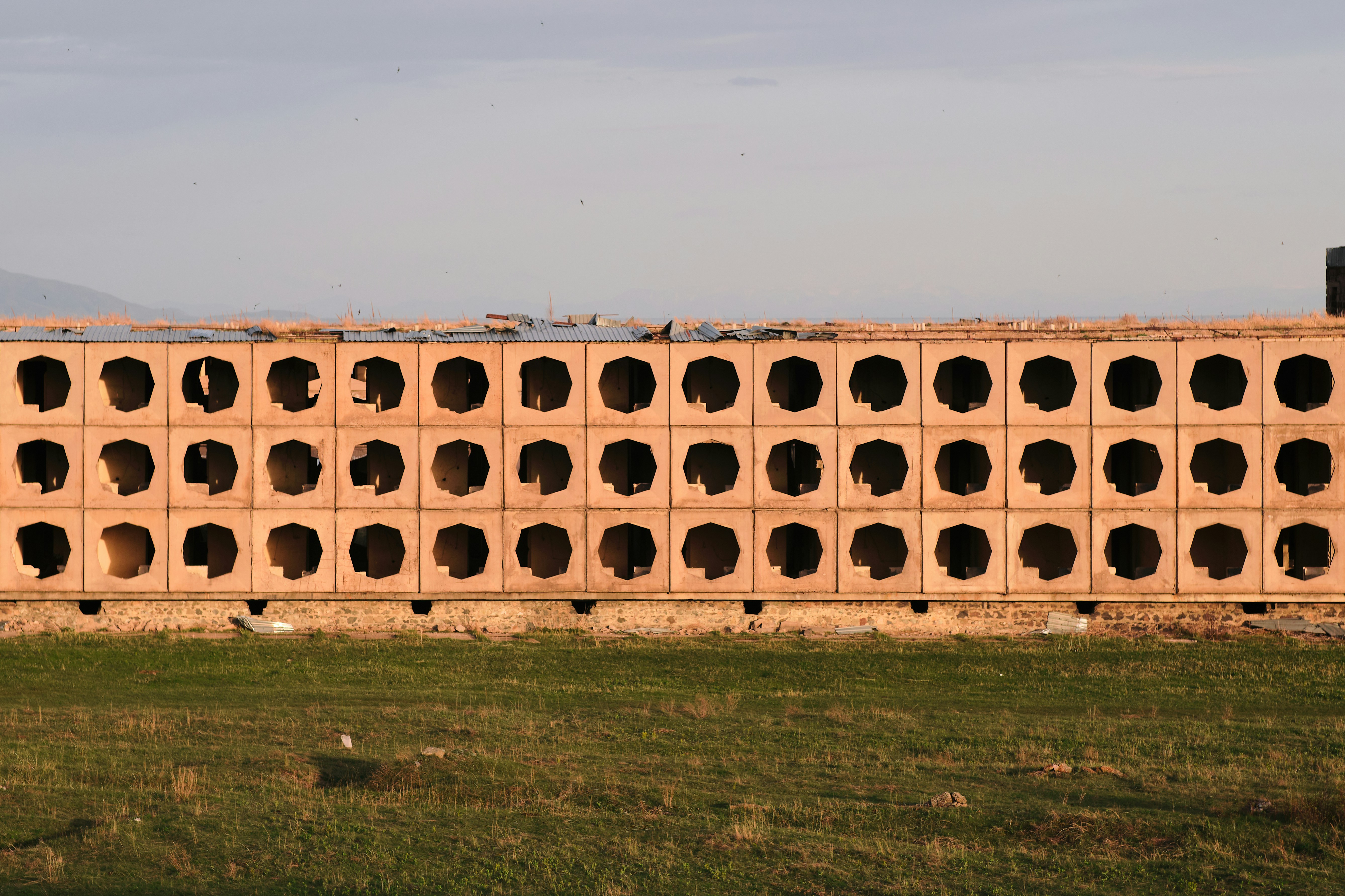 a large brick wall with holes in it