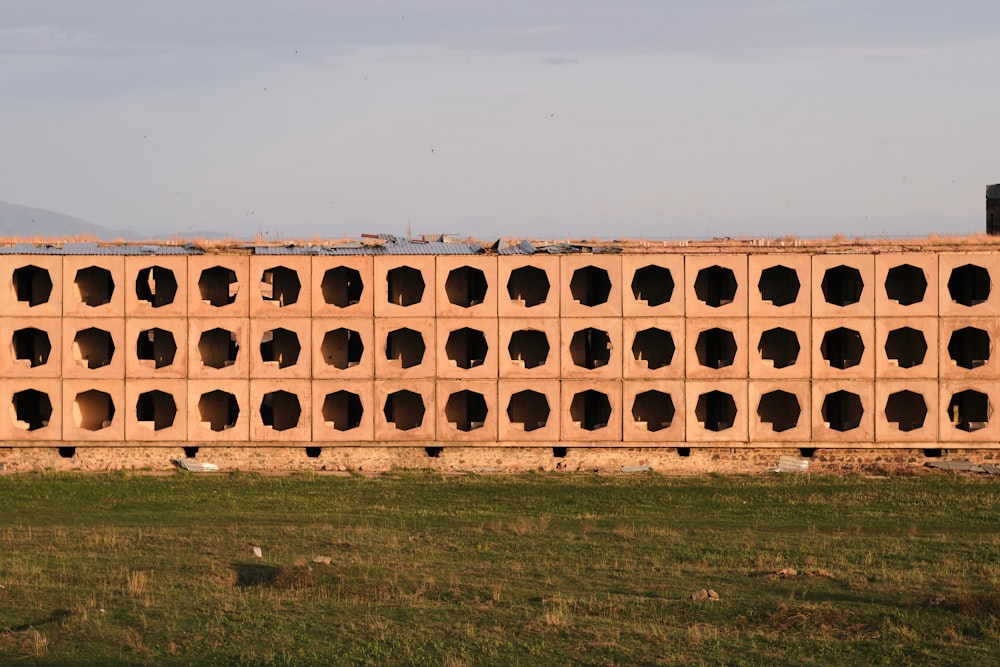 a large brick wall with holes in it