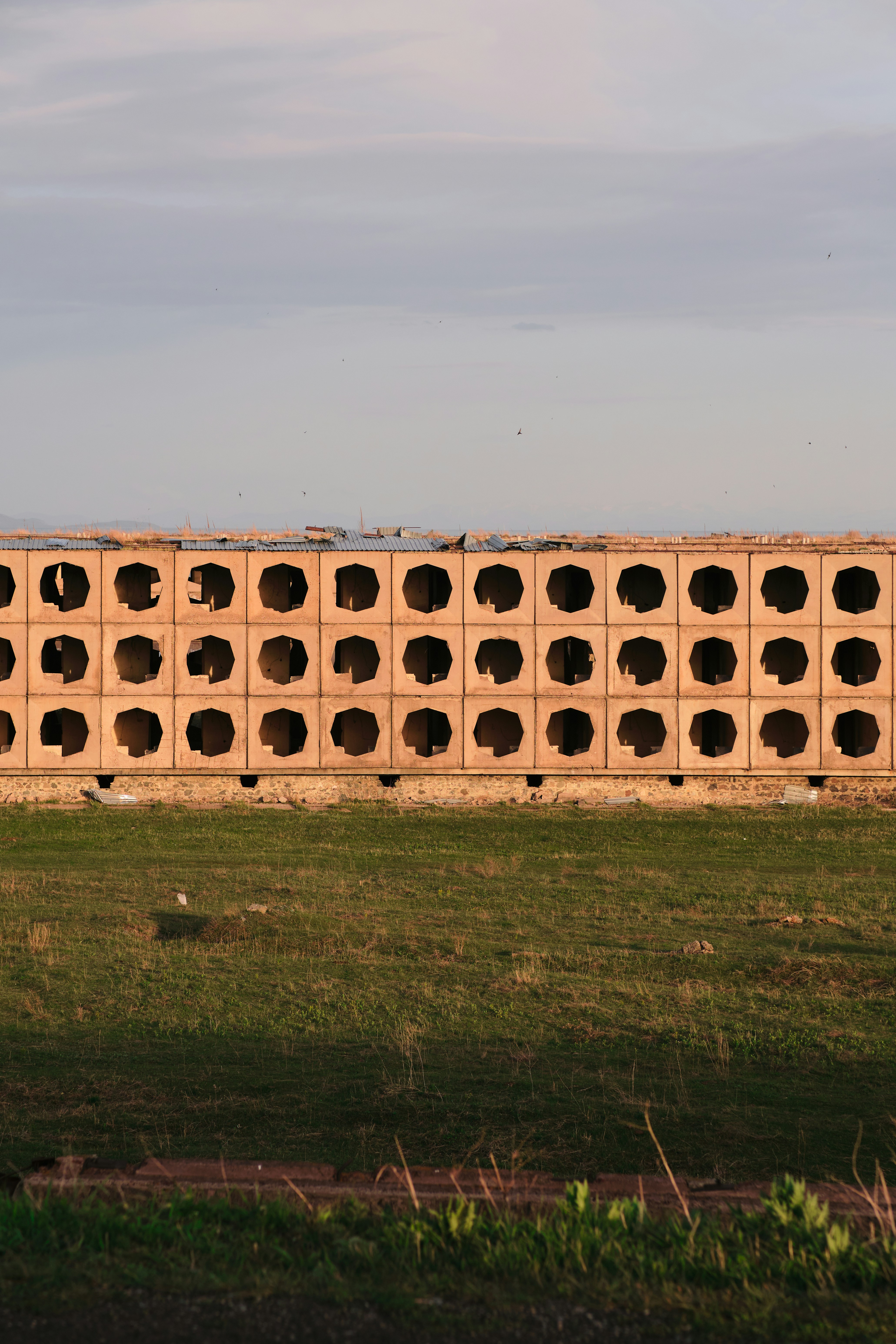 a large brick wall with holes in the middle of it