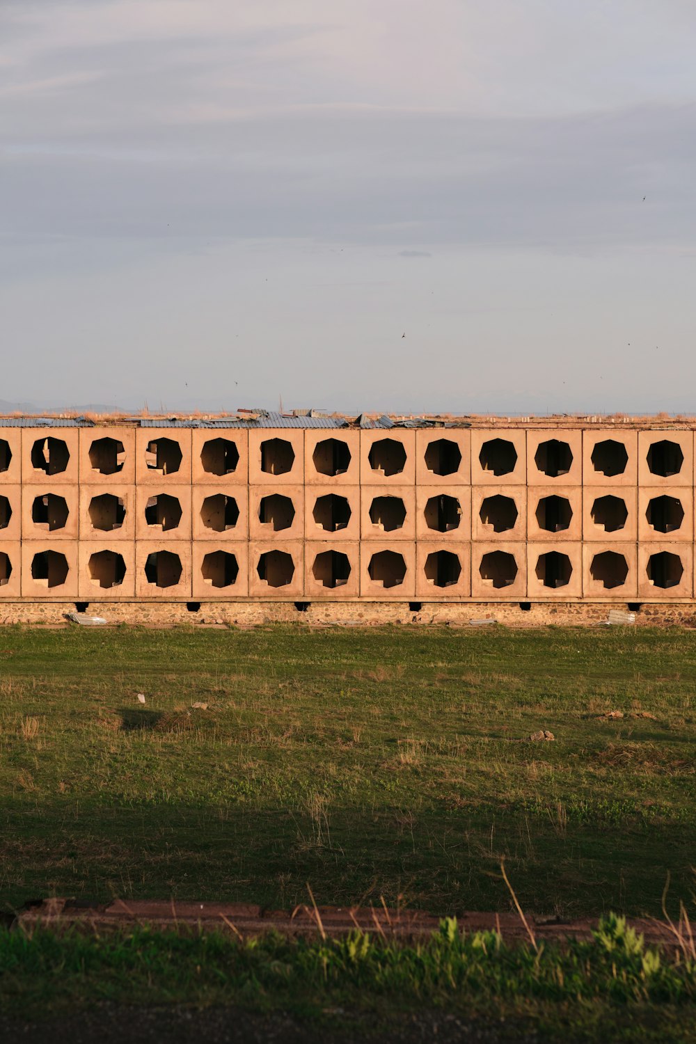 a large brick wall with holes in the middle of it
