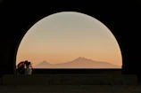 Couple enjoying a peaceful sunset at Arang Kel surrounded by towering pines.
