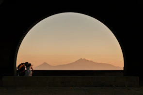 Couple enjoying a peaceful sunset at Arang Kel surrounded by towering pines.