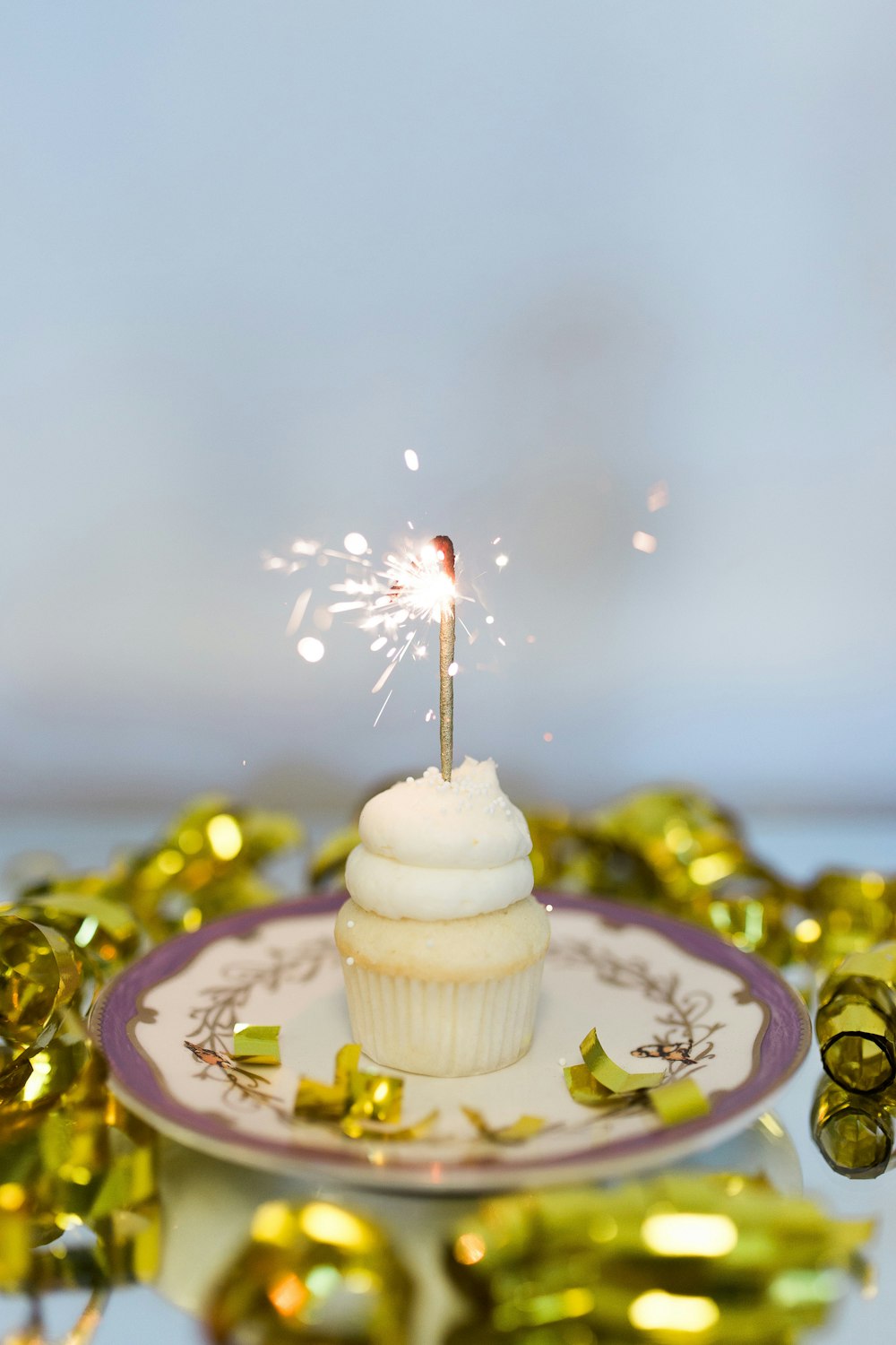 a cupcake with a sparkler sticking out of it