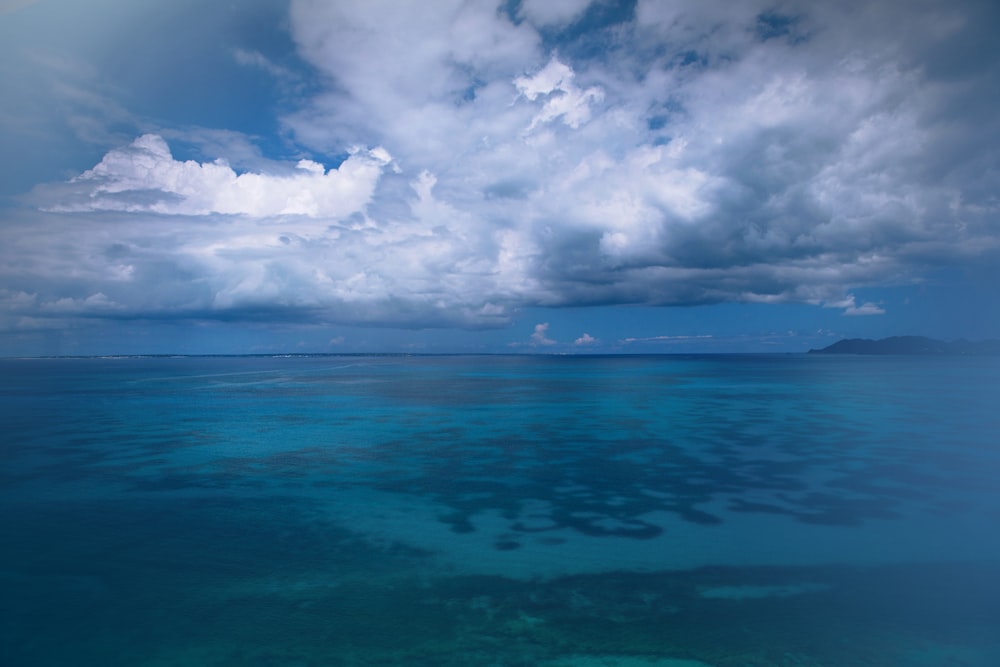 a large body of water under a cloudy sky