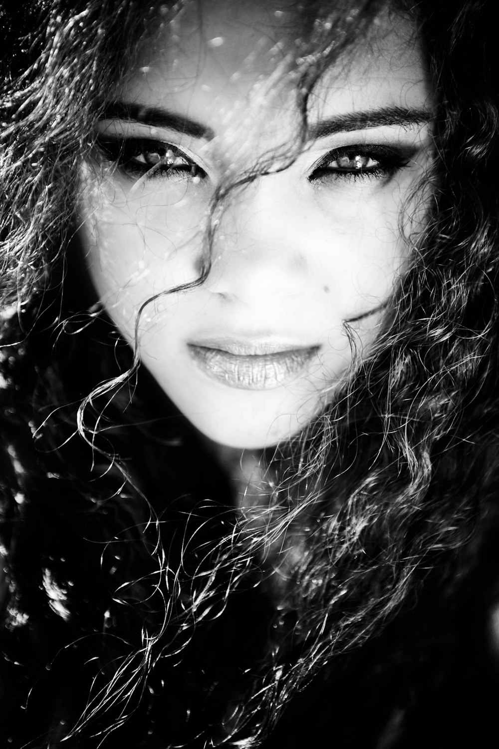 a black and white photo of a woman with long hair