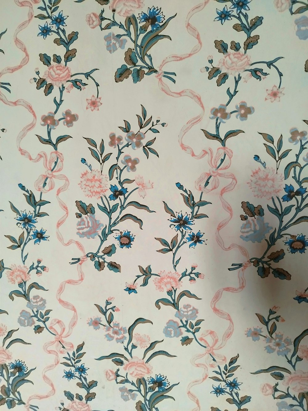 a floral wallpaper with blue and pink flowers