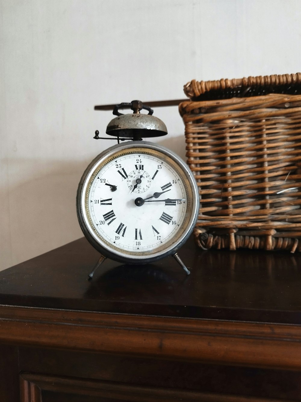 a clock sitting on top of a wooden table