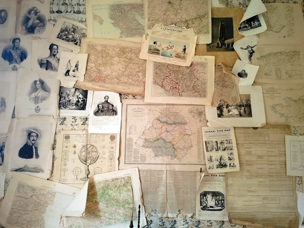 a table topped with lots of old maps