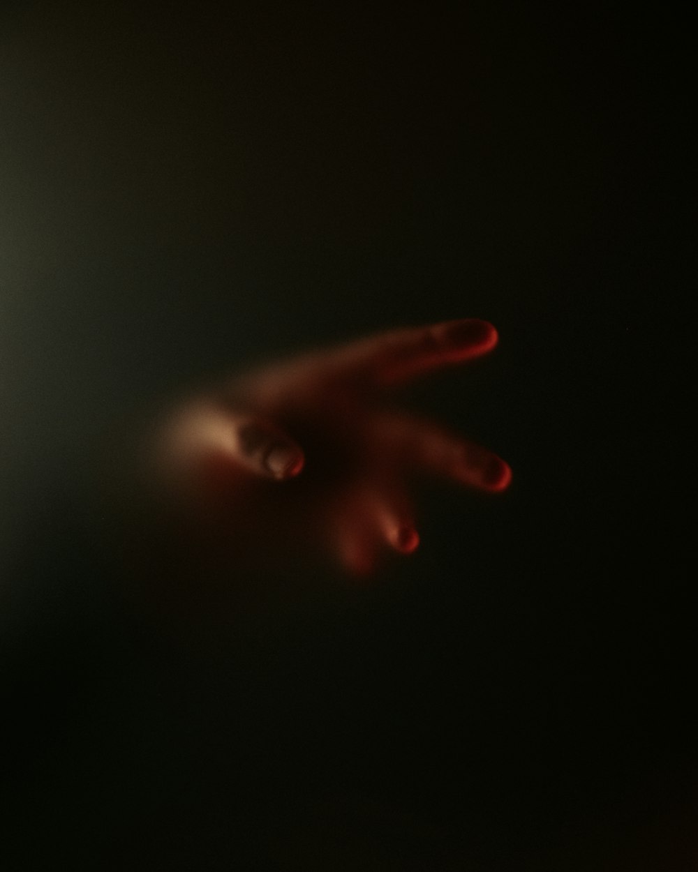 a blurry image of a person's hand in the dark