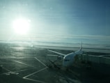 A clean, spacious shuttle van parked outside Eau Claire Regional Airport under a bright morning sky.